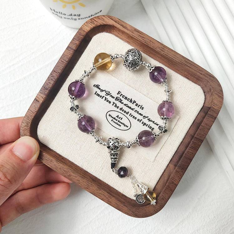 Amethyst and citrine charm multi-gemstone bracelet promoting healing, balance, and positive energy.
