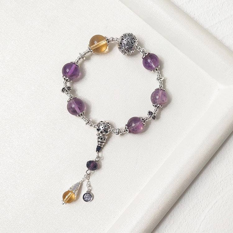 Amethyst and citrine charm multi-gemstone bracelet designed to promote healing, balance, and positive energy.

