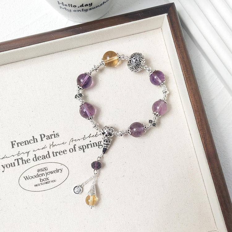 Multi-gem bracelet with amethyst and citrine charms, designed to enhance healing, balance, and positive energy.
