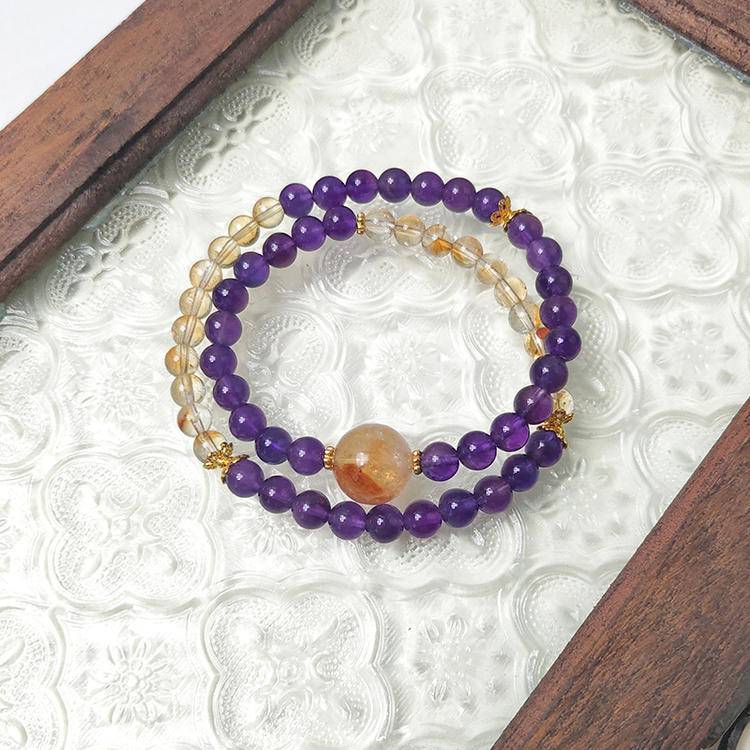 Healing double-strand bracelet featuring amethyst and citrine for emotional well-being and energy balance.
