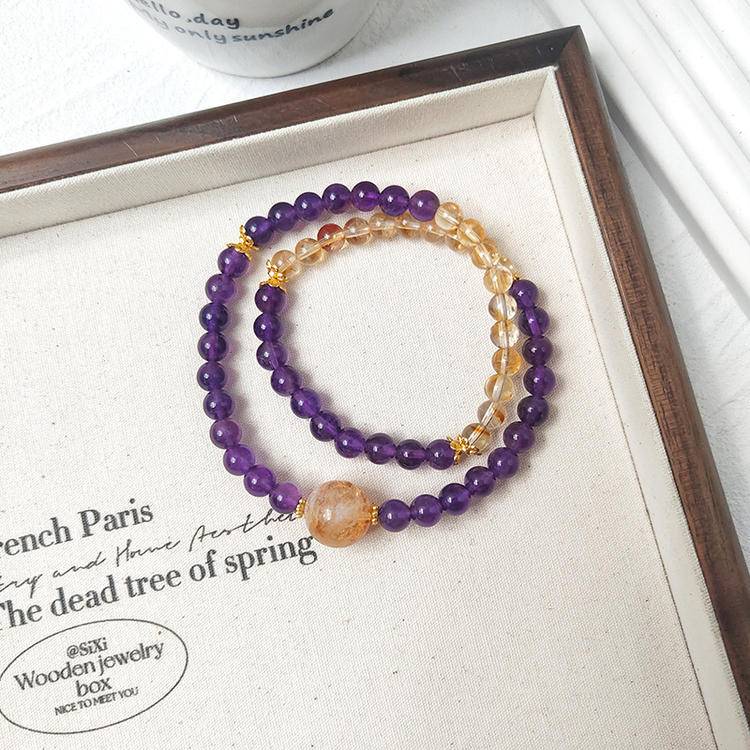 Amethyst and citrine double-strand bracelet promoting healing, balance, and positive energy.
