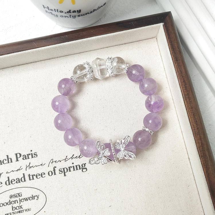 Healing multi-gemstone bracelet featuring amethyst and clear quartz butterfly for emotional well-being and energy balance.

