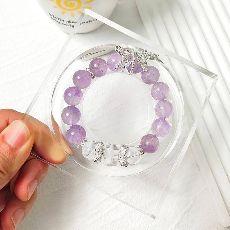Healing bracelet featuring amethyst and clear quartz butterfly for energy, balance, and emotional well-being.
