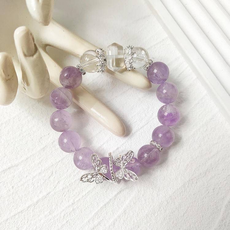 Amethyst and clear quartz butterfly bracelet supporting emotional balance, positive energy, and healing.
