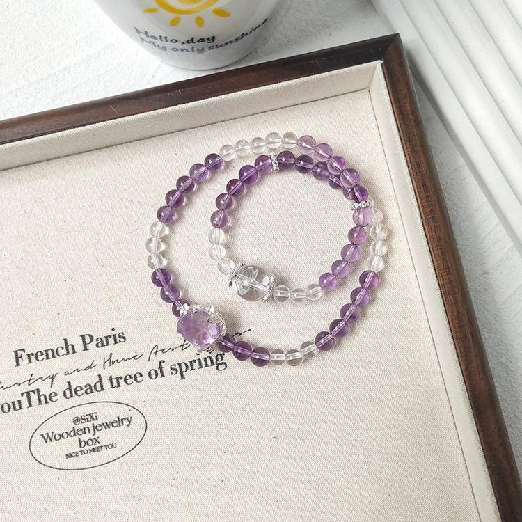 Healing double-strand bracelet featuring amethyst and clear quartz for emotional well-being and energy balance.
