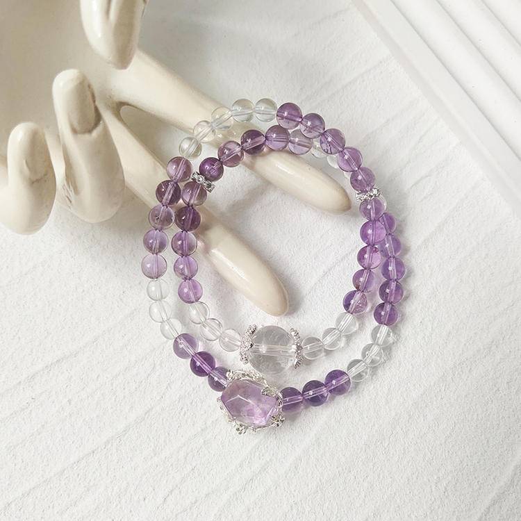 Amethyst and clear quartz double-strand multi-gemstone bracelet designed to promote healing, balance, and positive energy.
