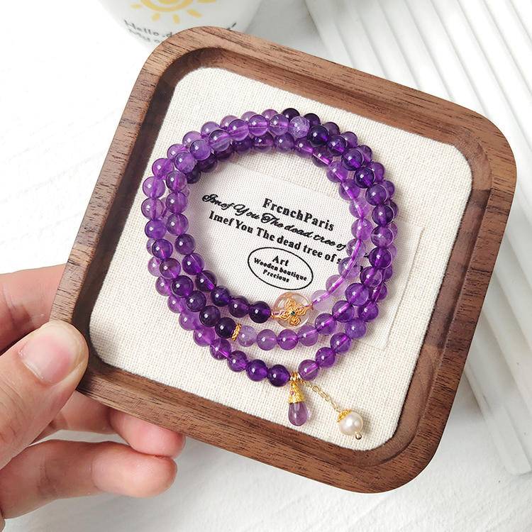 Amethyst, pearl, and silver quartz bracelet supporting emotional balance, positive energy, and healing.
