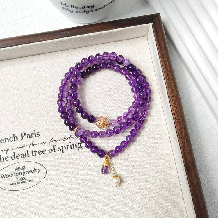Multi-gem bracelet with amethyst, pearl, and silver quartz, designed to enhance healing, balance, and positive energy.
