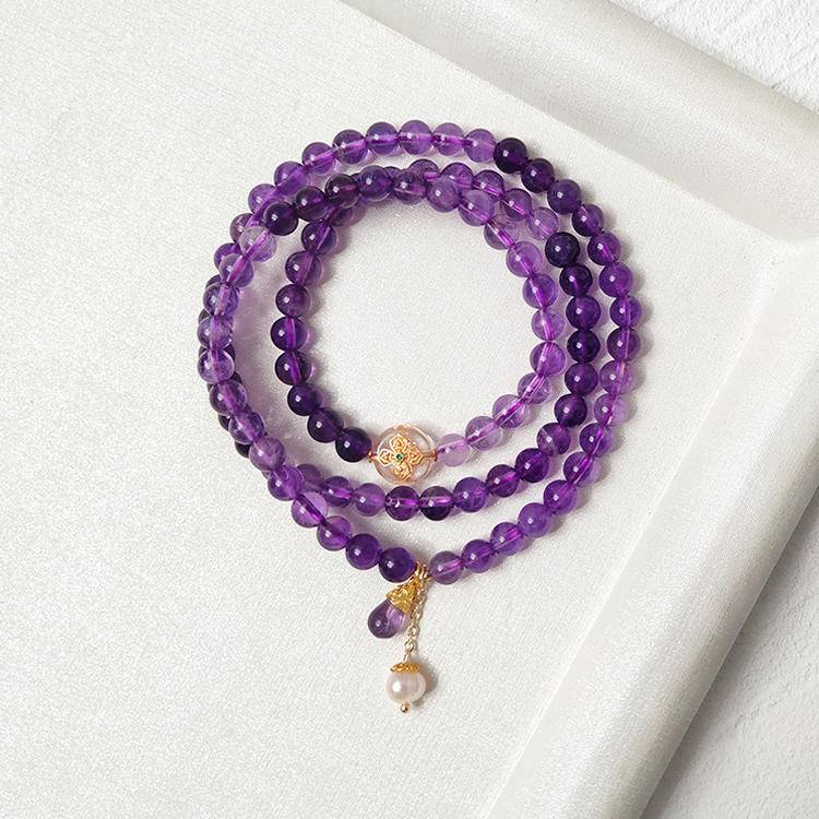 Healing multi-gemstone bracelet featuring amethyst, pearl, and silver quartz for emotional well-being and energy balance.
