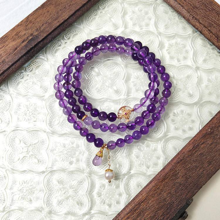 Amethyst, pearl, and silver quartz harmony bracelet promoting healing, balance, and positive energy.
