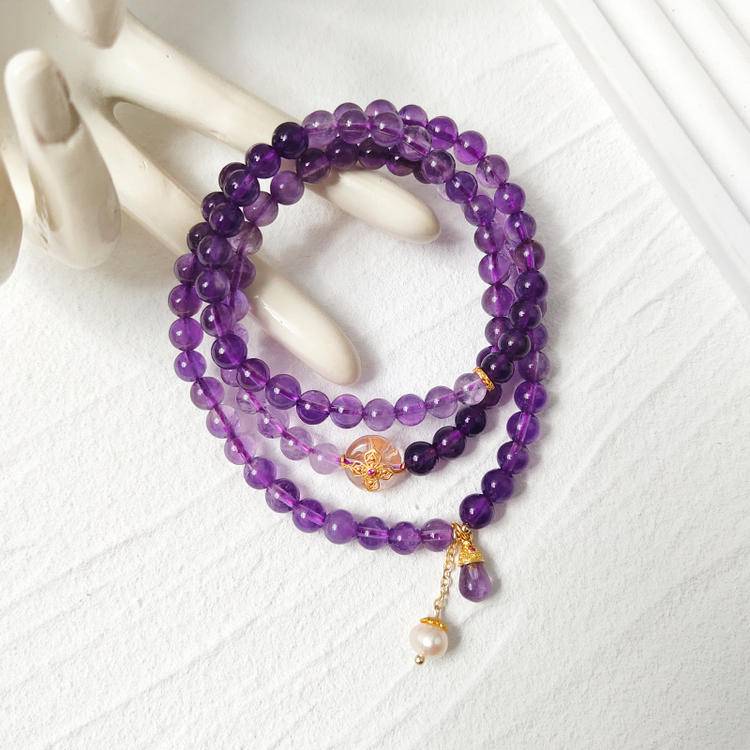 Amethyst, pearl, and silver quartz multi-gemstone bracelet designed to promote healing, balance, and positive energy.
