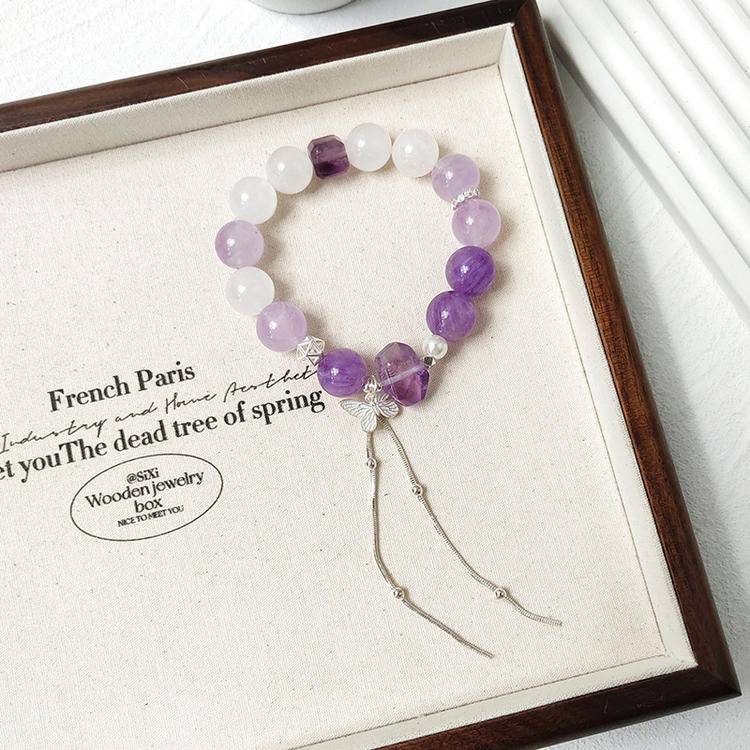 Healing multi-gemstone bracelet featuring amethyst and white phantom butterfly for emotional well-being and energy balance.
