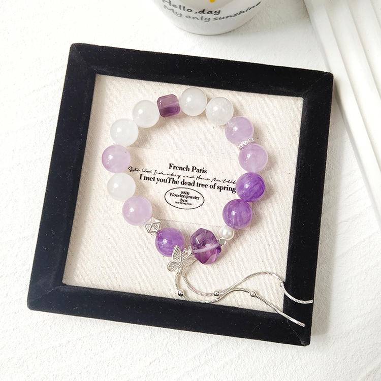 Healing bracelet featuring amethyst and white phantom butterfly for energy, balance, and emotional well-being.
