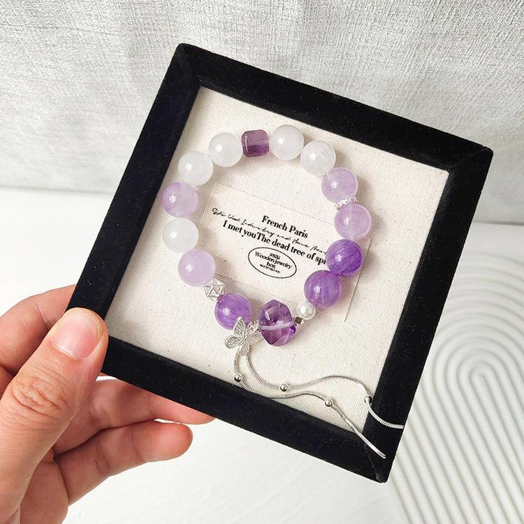 Amethyst and white phantom butterfly multi-gemstone bracelet designed to promote healing, balance, and positive energy.
