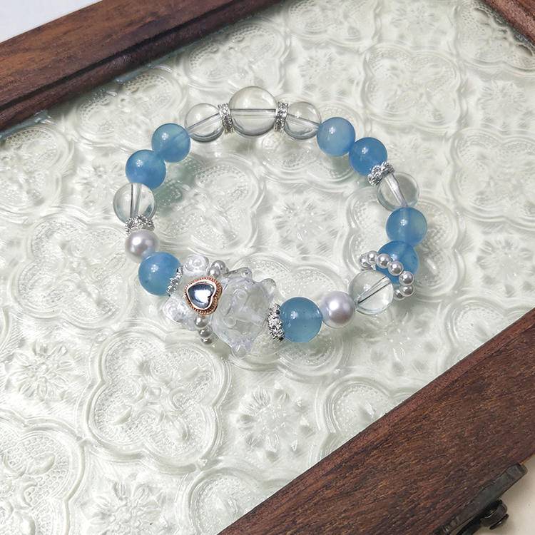 Multi-gem bracelet with aquamarine and bear charm designed to enhance clarity, energy, and healing.