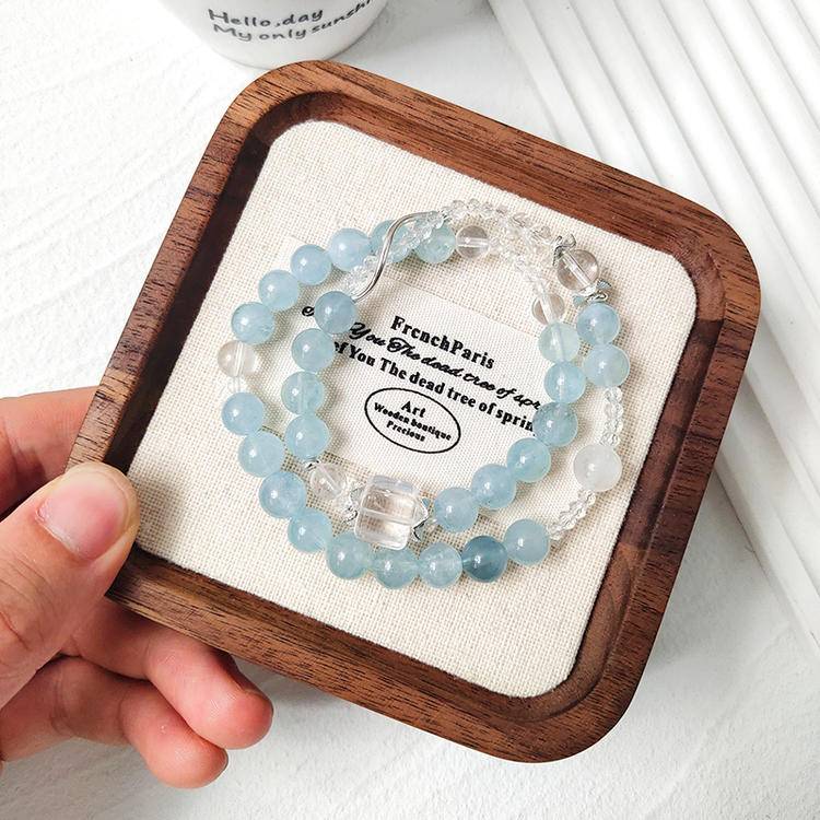 Healing double-wrap bracelet featuring aquamarine and clear quartz for emotional well-being and energy balance.
