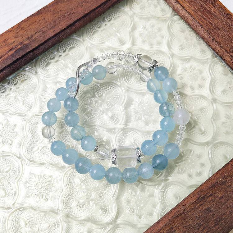 Double-wrap bracelet with aquamarine and clear quartz, designed to enhance healing, balance, and positive energy.
