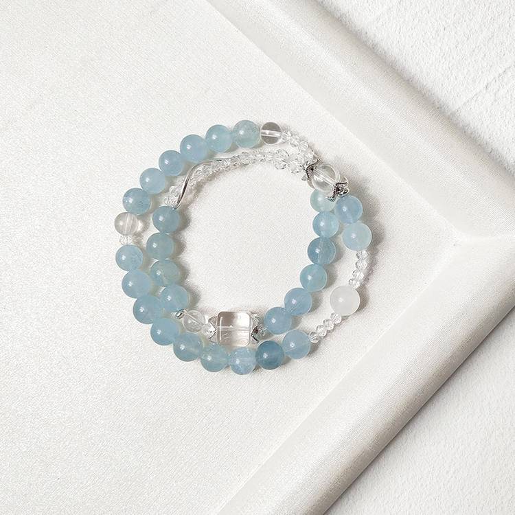 Aquamarine and clear quartz double-wrap bracelet designed to promote healing, balance, and positive energy.

