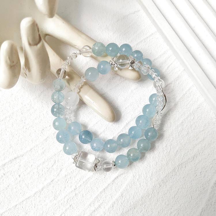 Aquamarine and clear quartz double-wrap bracelet supporting emotional balance, positive energy, and healing.
