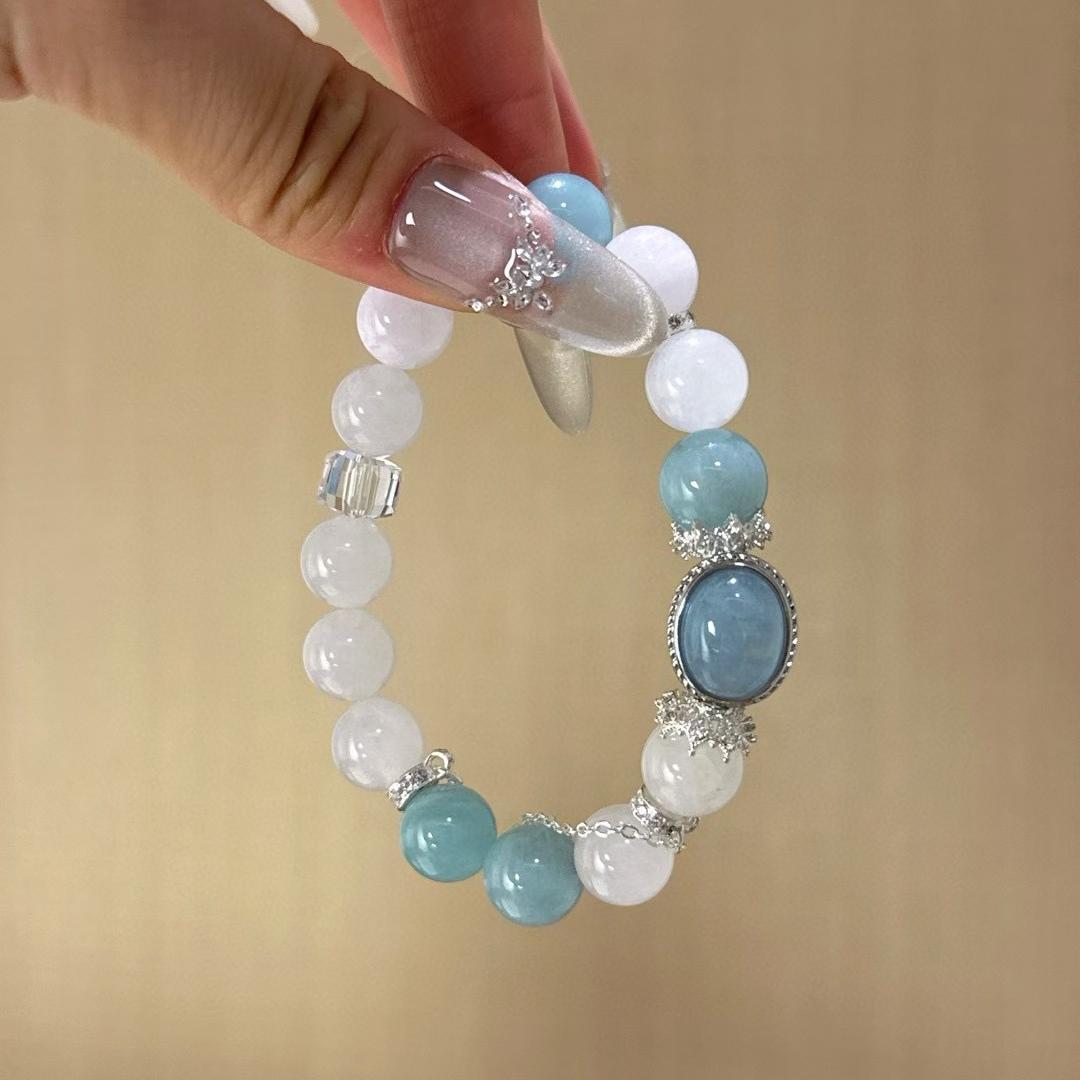 Aquamarine and white ghost quartz multi-gemstone bracelet designed to promote healing, balance, and positive energy.