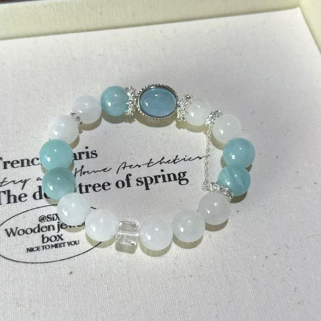 Aquamarine and white ghost quartz bracelet promoting healing, clarity, and positive energy.