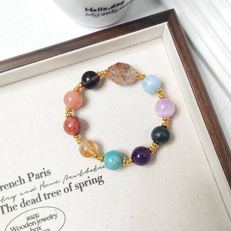 Healing black gold multi-gemstone bracelet featuring amethyst, sunstone, aquamarine, smoky quartz, lepidolite, citrine, and red jade flower, designed for balance and positive energy.