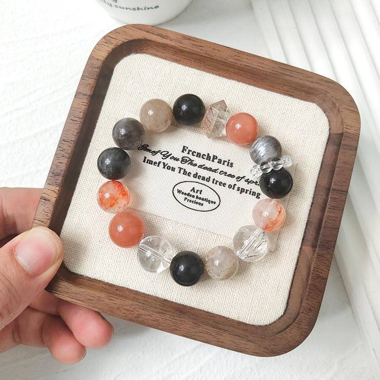 Black gold skeleton sunstone multi-gemstone bracelet with clear quartz, obsidian, and red jade flower for balance, healing, and positive energy.
