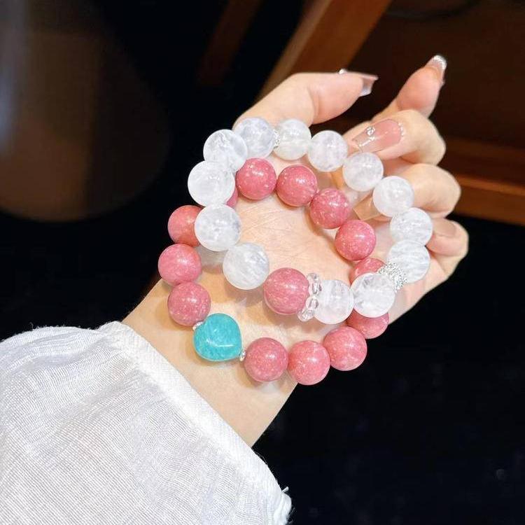 Rhodochrosite and snow phantom quartz bracelet set promoting harmony and emotional balance.