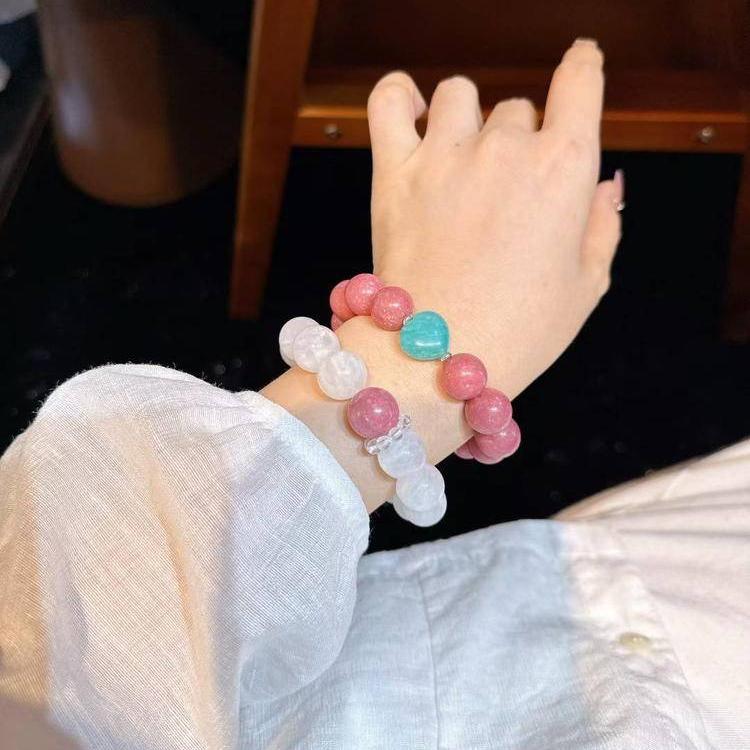 Elegant layered bracelet set with rhodochrosite and snow phantom quartz promoting emotional harmony.