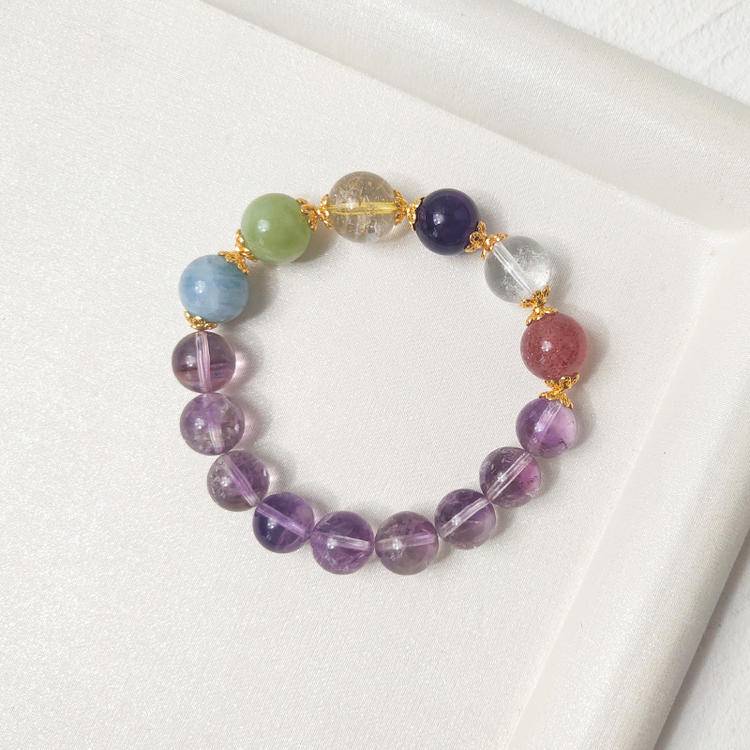 Multi-gemstone bracelet with Brazilian amethyst, clear quartz, fluorite, and aquamarine crystals, supporting healing, balance, and positive energy.
