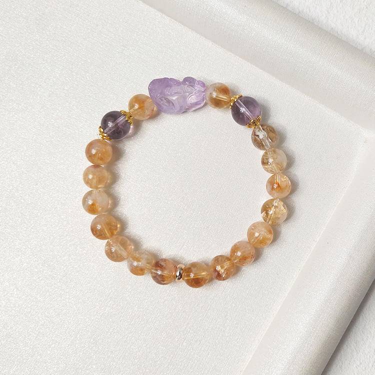 Multi-gem bracelet with citrine and amethyst Pi Xiu designed to enhance protection and positive energy.