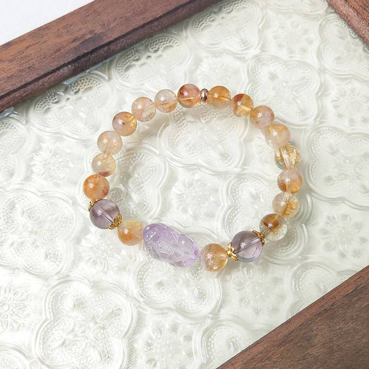 Healing multi-gem bracelet featuring citrine and amethyst for protection, energy, and focus