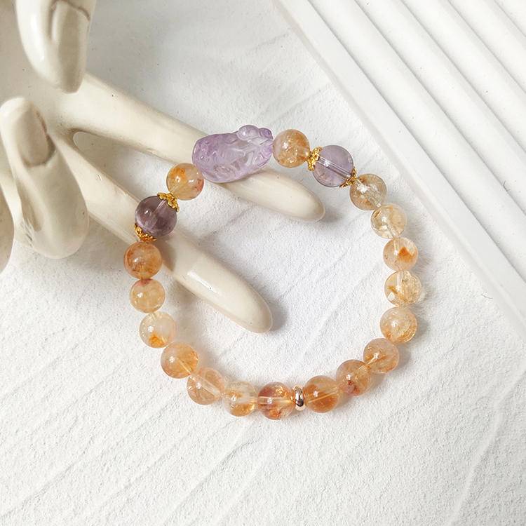 Healing bracelet featuring citrine and amethyst Pi Xiu for energy, clarity, and protection.
