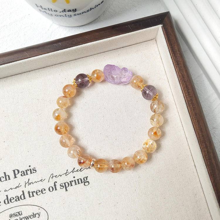 Citrine and amethyst Pi Xiu tower bracelet promoting protection, balance, and positive energy.