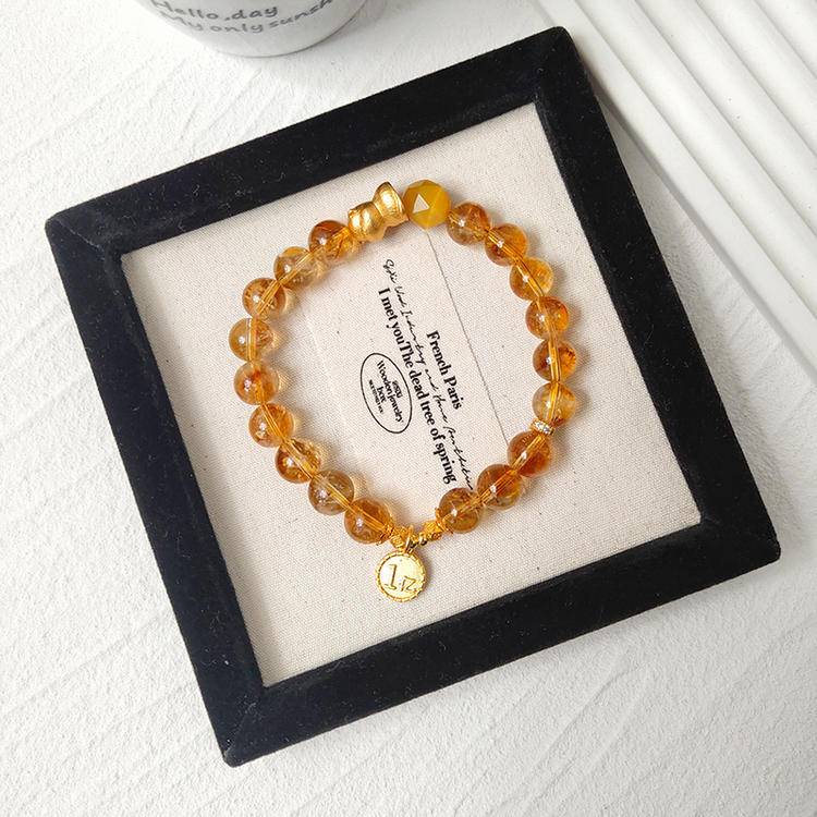 Multi-gem bracelet with citrine and lucky cat designed to enhance financial energy and positive intentions.