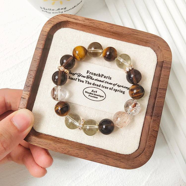 Multi-gem bracelet with citrine, tiger eye, and smoky quartz designed to enhance prosperity and positive energy.