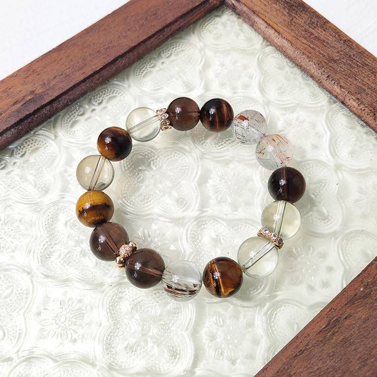 Citrine, tiger eye, and smoky quartz bracelet promoting prosperity, energy, and positive intentions.