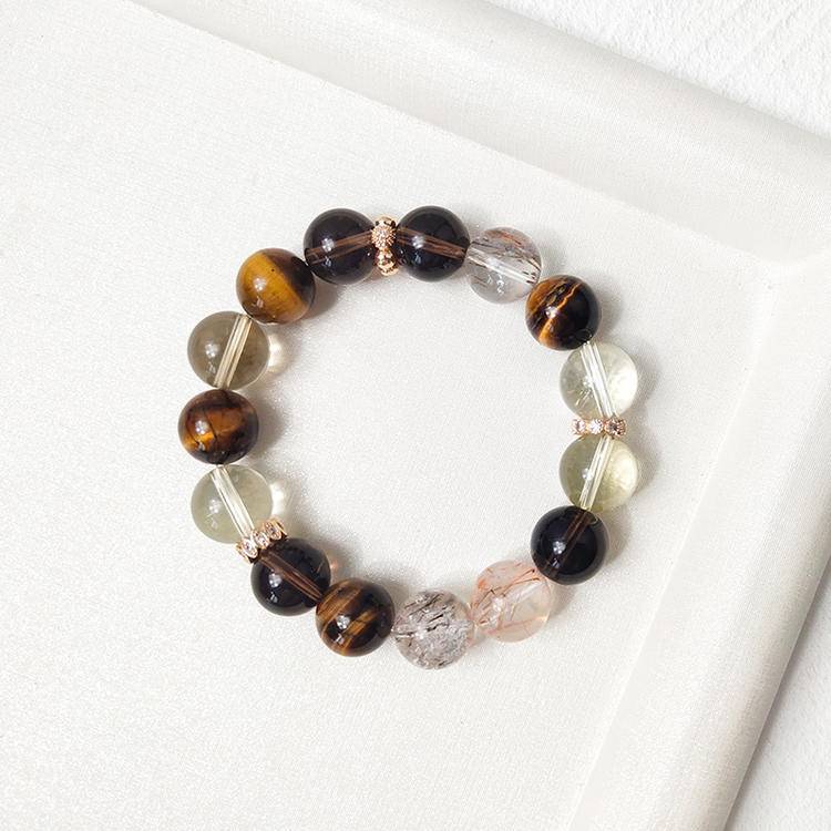 Citrine, tiger eye, and smoky quartz multi-gemstone bracelet designed to promote wealth, balance, and positive energy.