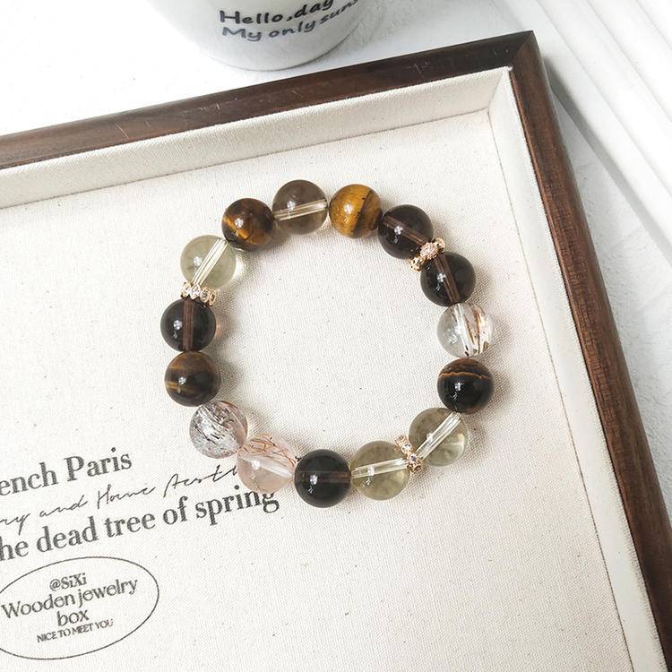 Citrine, tiger eye, and smoky quartz bracelet supporting financial energy, balance, and well-being.