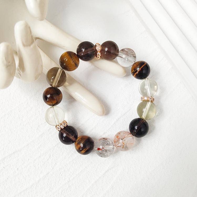 Healing multi-gem bracelet featuring citrine, tiger eye, and smoky quartz for wealth, balance, and focus.