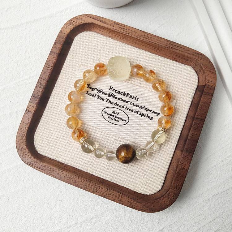 Citrine, tiger eye, and Zaki Lhamo bracelet promoting prosperity, energy, and positive intentions.