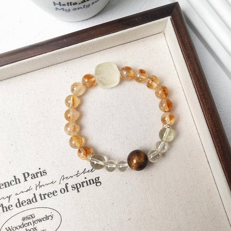 Healing multi-gem bracelet featuring citrine, tiger eye, and Zaki Lhamo for wealth, balance, and focus.