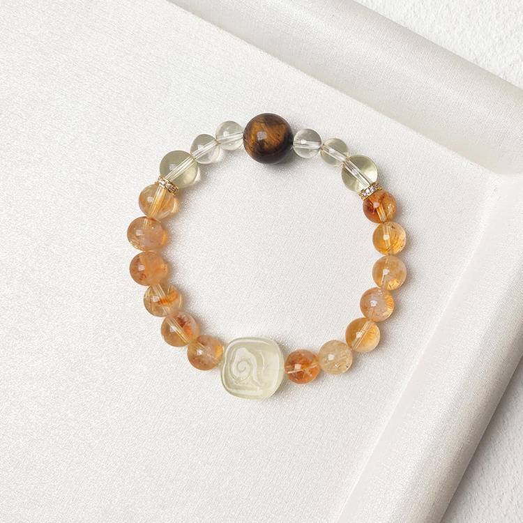 Citrine, tiger eye, and Zaki Lhamo bracelet supporting financial energy, balance, and well-being.
