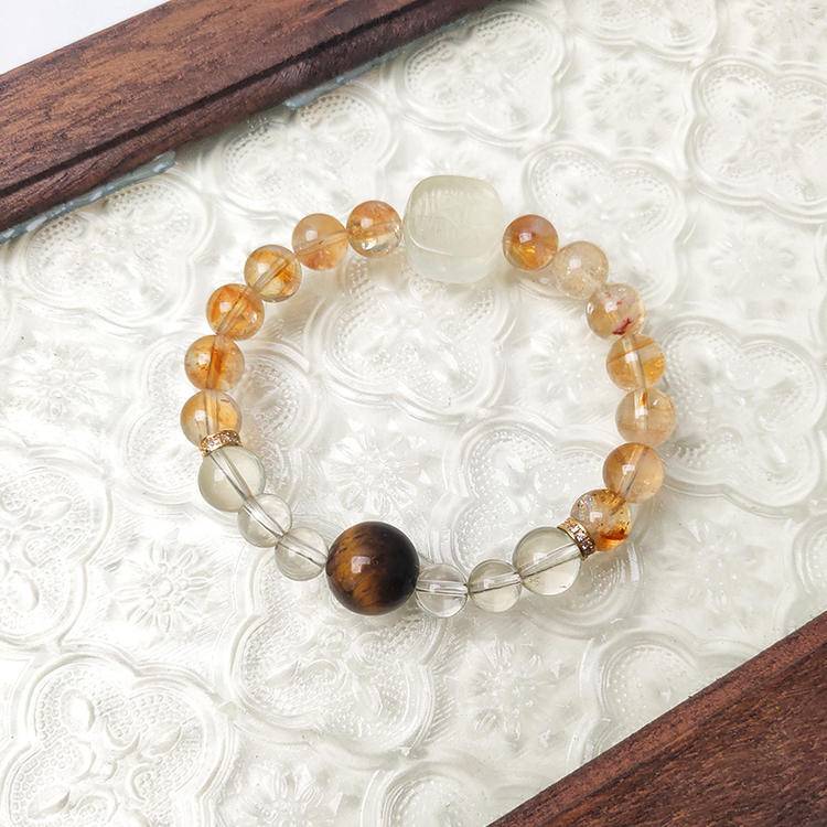 Multi-gem bracelet with citrine, tiger eye, and Zaki Lhamo designed to enhance prosperity and positive energy.