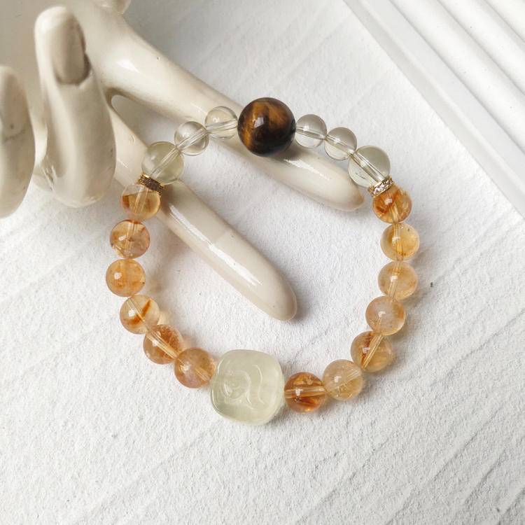 Citrine, tiger eye, and Zaki Lhamo multi-gemstone bracelet designed to promote wealth, balance, and positive energy.