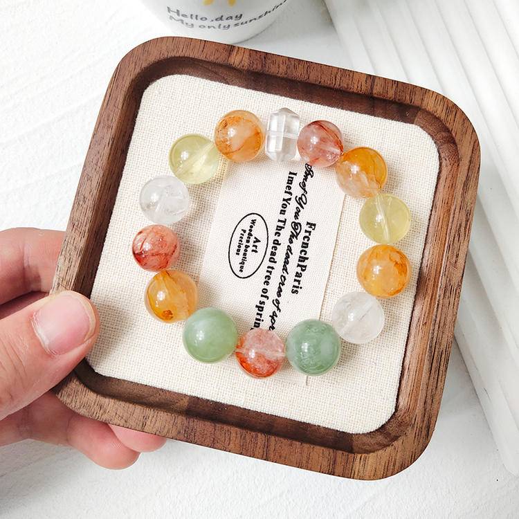 Healing multi-gemstone bracelet featuring citrine, yellow jade flower, fluorite, red jade flower, snow phantom quartz, and clear quartz for emotional well-being and energy balance.
