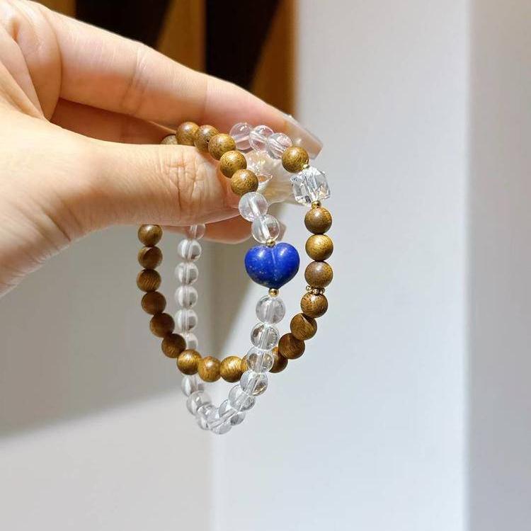Healing multi-wrap bracelet featuring clear quartz, agarwood, and lapis lazuli for emotional well-being and energy balance.
