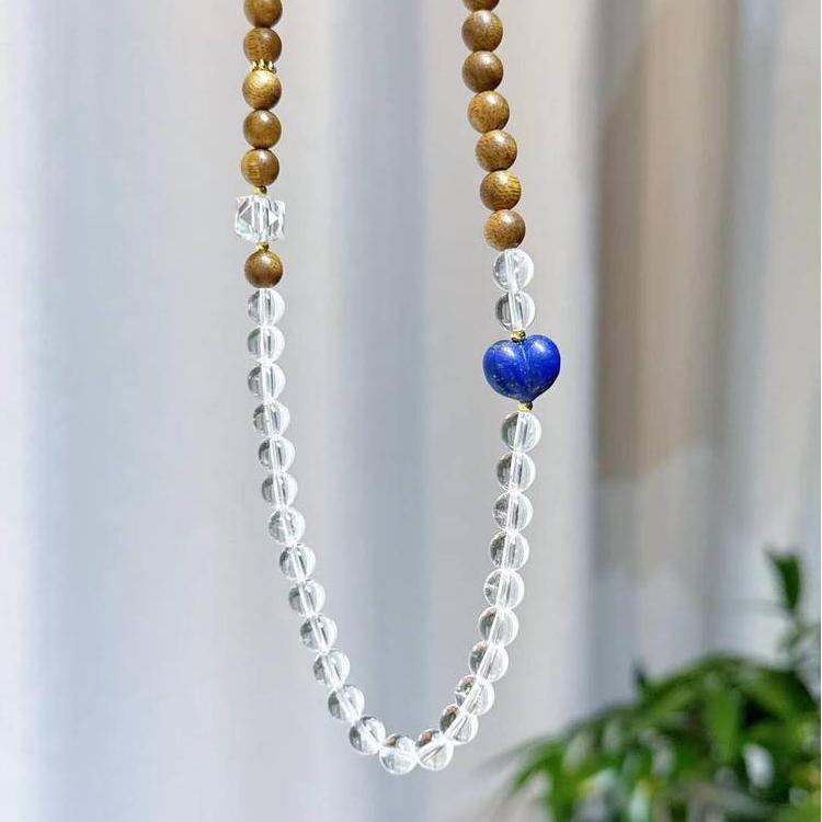 Clear quartz, agarwood, and lapis lazuli bracelet supporting emotional balance, positive energy, and healing.
