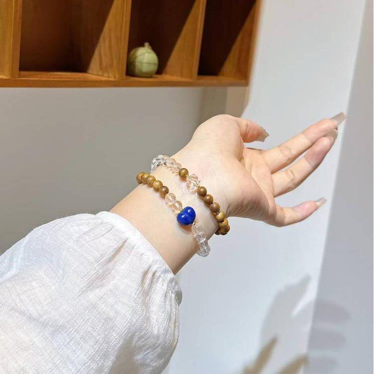 Multi-wrap bracelet with clear quartz, agarwood, and lapis lazuli, designed to enhance healing, balance, and positive energy.
