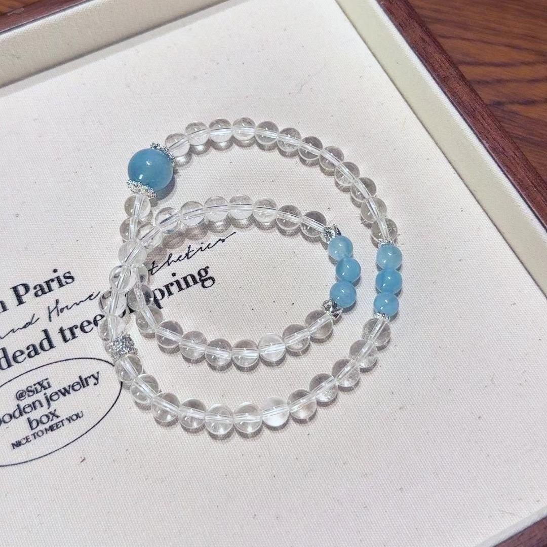 Clear quartz and aquamarine multi-layer bracelet promoting healing, balance, and positive energy.
